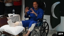 Pakistani former Prime Minister Imran Khan addresses journalists at a hospital in Lahore on November 4, a day after an assassination attempt. 