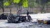 Afghan security officials inspect the scene of a bomb blast outside Kabul University on July 19.