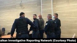 Goran Stanisic (center) in court in Pristina on October 5. 