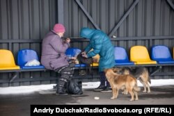 Жінки обідають на стільчиках очікування перед входом до КПВВ