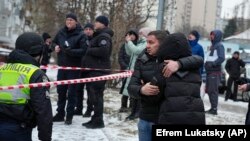 People react at the site of a Russian attack in Kyiv on January 23. 