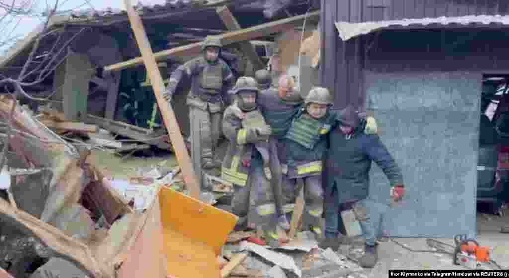 In a still image obtained from a video, a man is rescued from under the rubble in Zmiyiv.