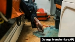 The body of a rescue worker lies inside an ambulance after Russian drone strikes on a residential neighborhood in Kharkiv on April 4.