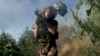 A Ukrainian soldier fires a rocket-propelled grenade launcher toward Russian positions at the front line close to Donetsk on August 19.