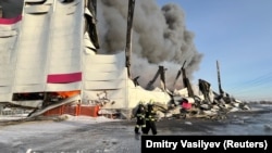 Firefighters work to put out the blaze at a warehouse of Wildberries online retailer in St. Petersburg, Russia, on January 13.