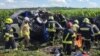 Emergency crews work at the site of a minibus crash that killed 14 people in Ukraine on July 6.