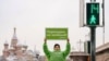 A lone Greenpeace protester in Moscow urges Russia to "go green."
