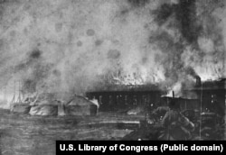 Russian soldiers watch as a building burns during the battle for Mukden, the final land engagement of the war.