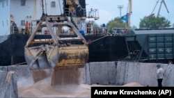 Workers load grain on a ship at a grain port in Izmayil, Ukraine.