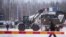 Vehicles of the Finnish Defense Forces are seen at the Vartius border station to provide assistance to the Border Guard to build a temporary barrier in Kuhmo, Finland, on November 19.