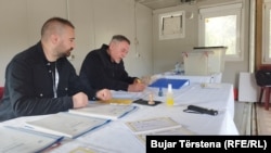 Electoral staff wait for voters at a polling center in Ujman, Zubin Potok, northern Kosovo, on April 23.