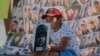 A boy holds up a photo as relatives and friends of Ukrainian missing soldiers and prisoners of war attend a protest in Kyiv on August 4.