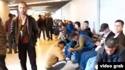 Tajiks and other Central Asians wait inside Vnukovo airport in Moscow as they look to enter Russia.