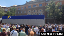 People in Sarajevo gather around a truck carrying the remains of Srebrenica victims to pay tribute on July 9.
