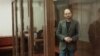 Russian opposition figure Vladimir Kara-Murza stands inside an enclosure for defendants during a court hearing in Moscow on April 17.