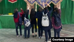 Unveiled schoolgirls protest against mandatory hijab in Iran's Isfahan Province on April 10.