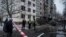 Ukrainian police officers at the scene of a Russian missile strike, which damaged an apartment building in Kyiv on December 13. 