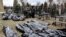 Bodies are lined up for identification by forensic personnel in the cemetery in Bucha, north of Kyiv, on April 6, 2022, after hundreds of civilians were found dead in areas from which Russian troops had withdrawn.