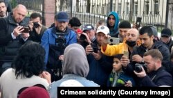 Advokat, vatandaş jurnalistleri ve «Qırım birdemligi» cemaat areketiniñ faalleri Qırım garnizon arbiy mahkemesiniñ binası ögünde, 2023 senesi