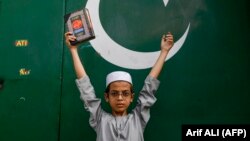 A boy holds the Koran during an anti-Sweden demonstration in Lahore, Pakistan, on July 9.