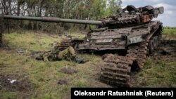 The body of a Russian soldier is seen near a destroyed Russian tank in the village of Storozheve in the Donetsk region on June 14.