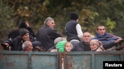 ARMENIA - Refugees from Nagorno-Karabakh ride in the back of a truck as they arrive in the Armenian border village of Kornidzor, September 26, 2023.