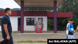 Nagorno-Karabakh - People walk past a closed gas station in Askeran, July 18, 2023.
