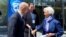 Ukrainian Prime Minister Denys Shmyhal, accompanied by Ukrainian Ambassador to the United States Oksana Markarova (center), talks with European Central Bank President Christine Lagarde near the IMF building in Washington on April 13.