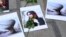 Flowers are seen on a portrait of Mahsa Amini during a demonstration in front of the Iranian embassy in Brussels, Belgium on Sept. 23, 2022,