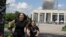 A family runs from an explosion after a Russian missile strike on a residential neighborhood in Pervomayskiy, in Ukraine's northeastern Kharkiv region, on July 4.