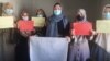 Afghan women stage a protest for women's rights to mark International Women's Day in Afghanistan.