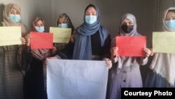 Afghan women stage a protest for women's rights to mark International Women's Day in Afghanistan.