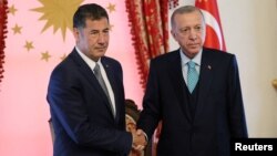 Սինան Օղանը և Ռեջեփ Թայիփ Էրդողանը: 