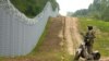A Latvian border guard patrols along the fence at the border with Belarus near Robeznieki. 