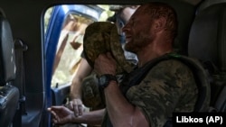 A wounded Ukrainian soldier reacts during evacuation from the front line near Bakhmut on August 30.