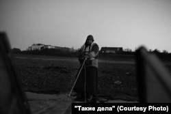 Father Mikhail pulls the boat ashore.