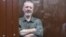 Russian nationalist Kremlin critic and former military commander Igor Girkin, also known as Igor Strelkov, who is charged with inciting extremist activity, sits in a defendents' box at a court hearing in Moscow on July 21.