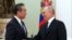 Russian President Vladimir Putin (right) greets Chinese foreign policy chief Wang Yi at the Kremlin in Moscow on February 22. The United States and NATO have accused China of considering supplying arms to Russia.