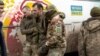 An injured Ukrainian prisoners of war is helped by comrades following a prisoner swap with Russia in April last year. 