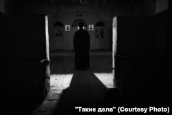 Father Mikhail stands in his village church in Antsiferovo.