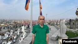 Armenia - Artak Beglarian poses for a photograph at the Yerablur military cemetery in Yerevan, October 1, 2023