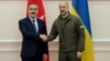 Ukrainian Prime Minister Denys Shmyhal (right) with Turkish Foreign Minister Hakan Fidan in Kyiv on August 25.
