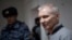 Aleksei Moskalyov is escorted from a courtroom in Yefremov in Russia's Tula region in March. 