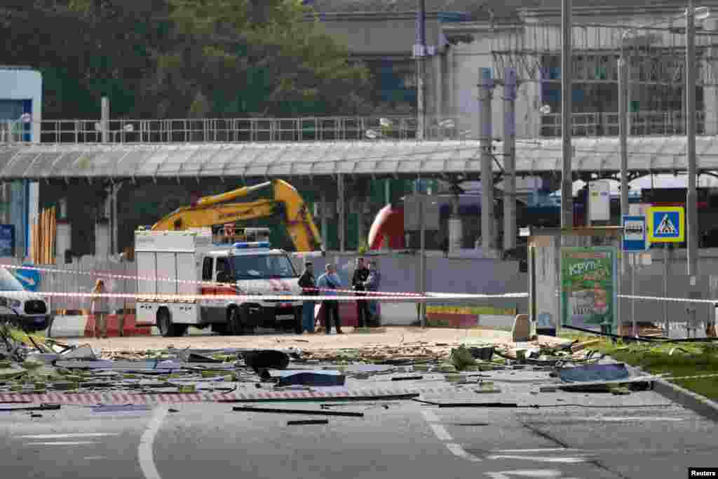Members of the security services investigate the site where the debris landed after the reported drone attack. The attack came a day after Kyiv vowed to &quot;retaliate&quot; for a Russian missile attack on the Black Sea port of Odesa. &nbsp;