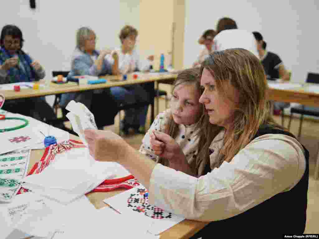 Жителька Праги Тереза ​​вчиться українській техніці вишивання разом зі своєю дочкою Аріаною під час уроку в Празі. Чехія, 17 травня 2024 року