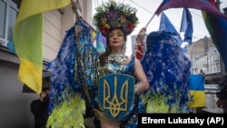 People take part in the annual Pride parade under the protection of riot police in Kyiv on June 16. 