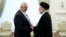In this photo released by the Iranian president's office, President Ebrahim Raisi (right) greets the leader of the Palestinian militant group Hamas, Ismail Haniyeh, in Tehran on June 20.