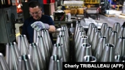 An employee handles 155 mm caliber shells after the manufacturing process at the Scranton Army Ammunition Plant (SCAAP) in Scranton, Pennsylvania on April 16, 2024