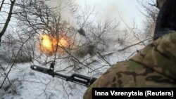 Ukrainian soldiers fire a 2S1 Gvozdika self-propelled howitzer toward Russian positions near the town of Chasiv Yar in the Donetsk region.