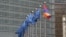 Belgium - EU and Armenian flags fly outside the EU headquarters in Brussels.